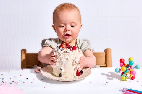 A baby attacking her First Birthday Smash Cake  - select to zoom