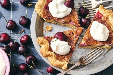 3 slices of Cherry-Vanilla Cream Pie in a pie dish topped with whipped cream - select to zoom