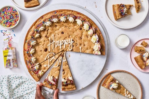 Chocolate Chip Cookie Cake on a counter with slices removed.