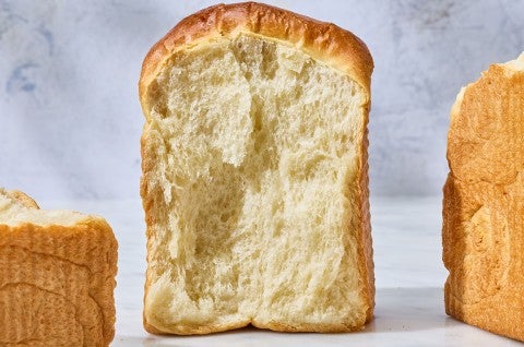 Sourdough Milk Bread on a counter with an angle that shows the moist interior - select to zoom