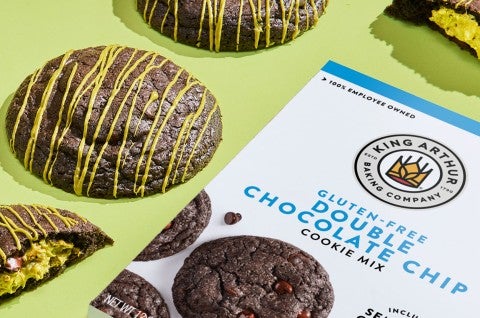 Gluten-Free Double Chocolate Pistachio Cookes on a green counter with a box of Gluten Free Double Chocolate Chip mix. - select to zoom
