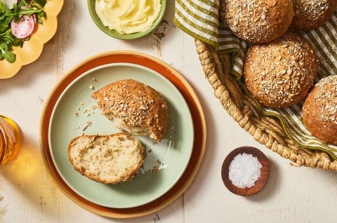 A Gluten-Free Seeded Hearth Roll split on a plate. - select to zoom