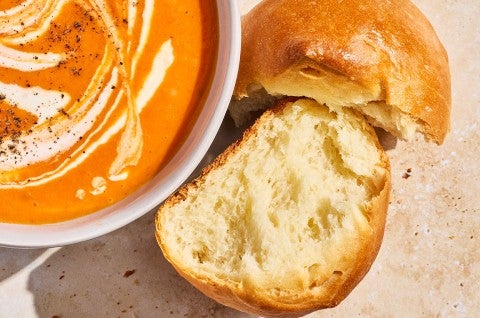 A Soft Golden Bun split apart to show the moist and bready interior. - select to zoom