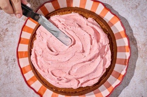 Spreading frosting on a Brown Sugar Strawberry Frosted Cake - select to zoom