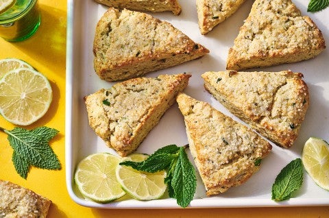 Mojito Scones on a platter with limes and mint leaves decorating the photo. - select to zoom
