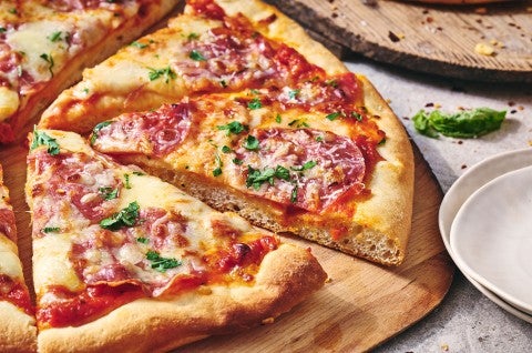 A slice of pizza slightly removed from a full pie - select to zoom