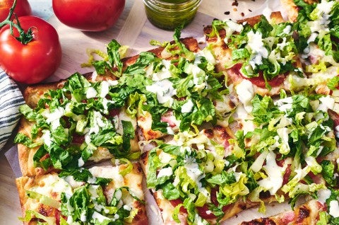 BLT Pizza sliced and covered with freshly chopped lettuce - select to zoom