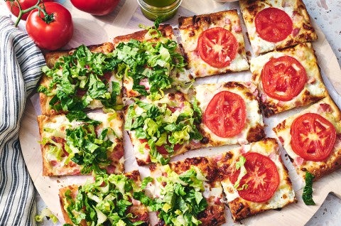 BLT Pizza with half covered with freshly chopped lettuce - select to zoom