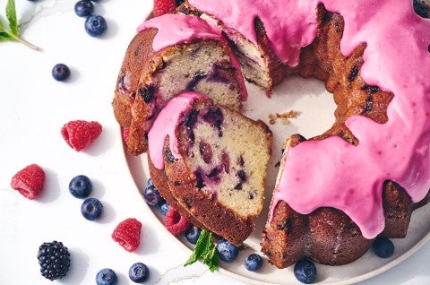 Berry Bliss Bundt Cake sliced and showing a beautiful pink glaze covering the cake - select to zoom