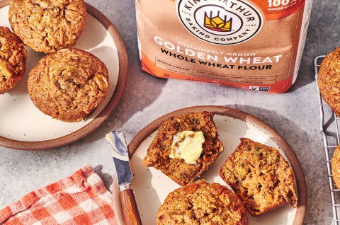 Morning Glory Muffins on plates and a bag of King Arthur Baking Golden Wheat flour. - select to zoom