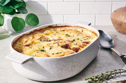 Scalloped Potatoes fresh out of the oven in a stoneware pan - select to zoom