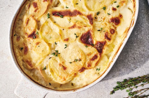 Scalloped Potatoes fresh out of the oven in a stoneware pan seen from above - select to zoom