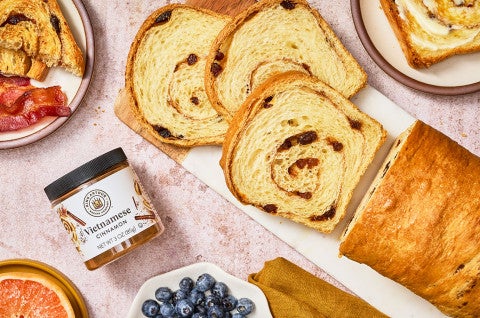 Sourdough Cinnamon Raisin Bread sliced on a counter and seen from above - select to zoom