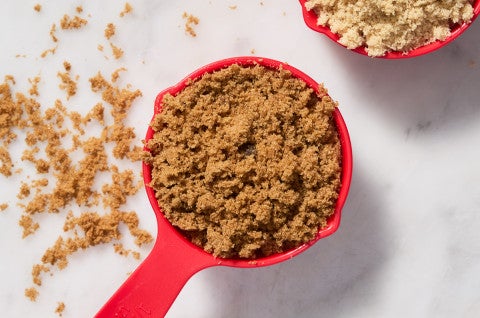 Measuring cup full of brown sugar