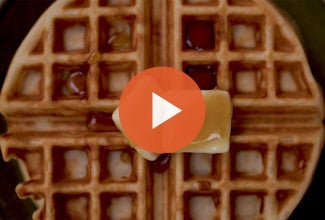 A belgian style yeasted waffle with a play icon over it. - select to zoom