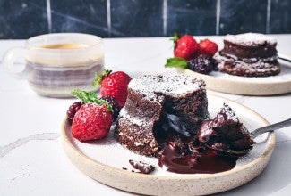 Flourless Chocolate Lava Cake on a white plate sitting on a counter