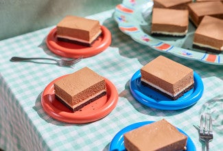 No-Bake Chocolate Cheesecake Bars arranged on a table