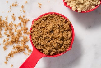 Measuring cup full of brown sugar