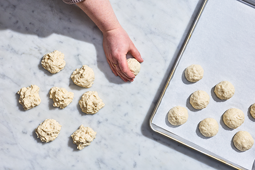 Shaping Gluten-Free Roll dough into balls.