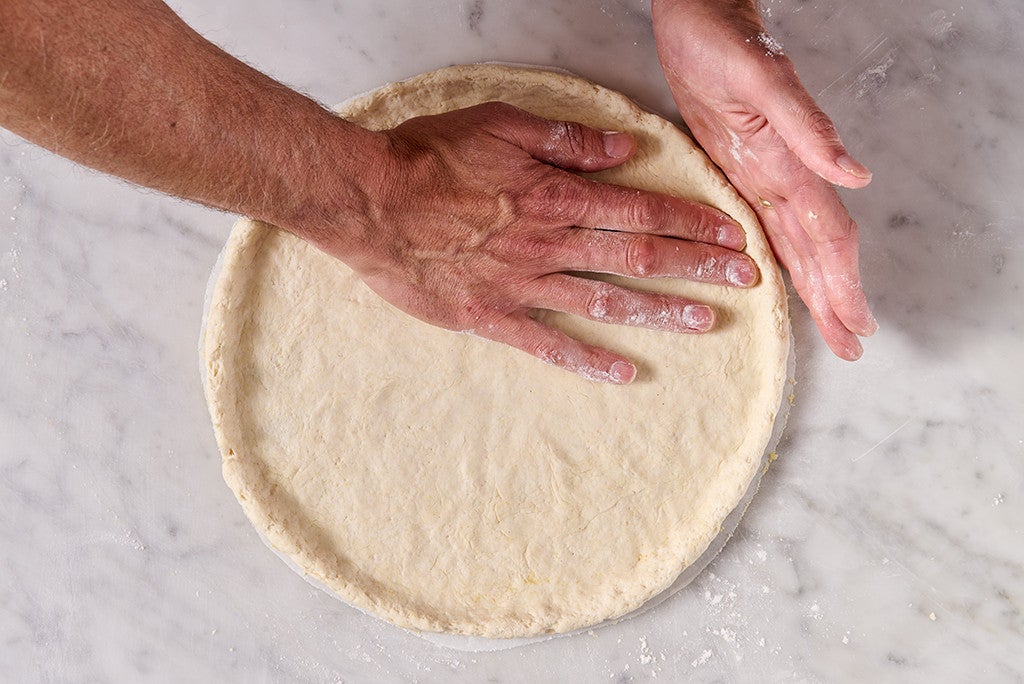 Shaping Gluten Free NY Style Pizza on a counter, seen from above.