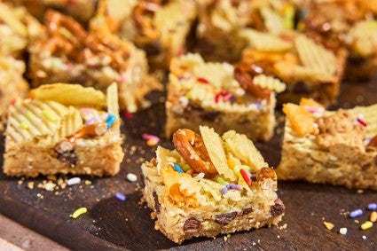 Cut-up pieces of Kitchen Sink Cookie Bars on a counter