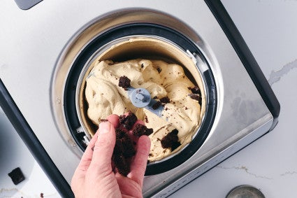 Adding chocolate cake crumbles to churning ice cream 