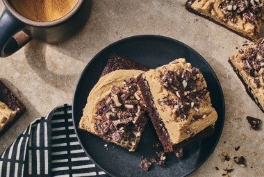 Chocolate Caramel Almond Crunch Brownies on a beautiful table setting seen from above.