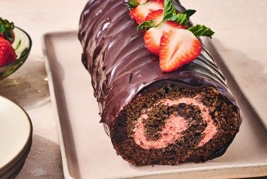Chocolate Strawberry Roll Cake on a sheet pan