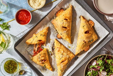 Flaky Puff Crust Pizza Turnovers on a baking sheet